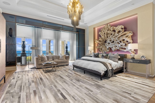 bedroom with a raised ceiling, ornamental molding, and light hardwood / wood-style flooring