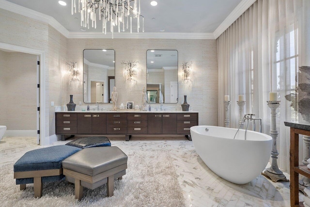 bathroom with double sink, crown molding, a bathing tub, an inviting chandelier, and large vanity