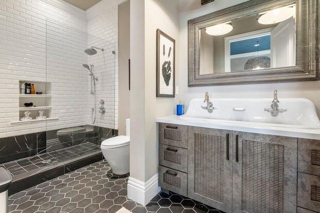 bathroom with toilet, tile floors, a tile shower, and vanity