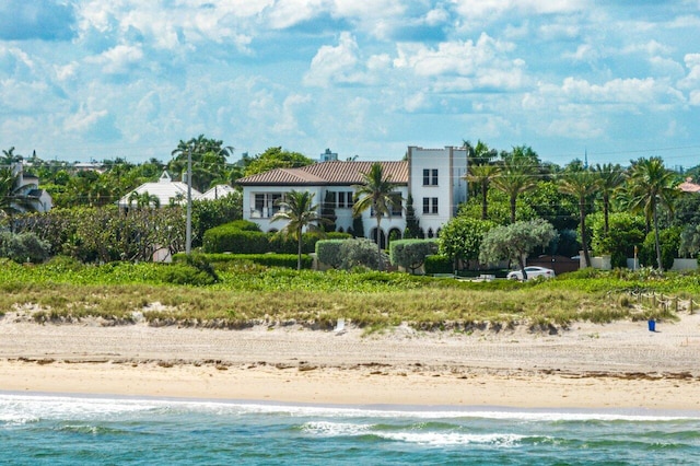 exterior space featuring a water view and a view of the beach