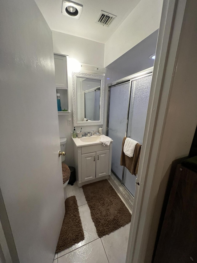 bathroom with toilet, tile flooring, and oversized vanity