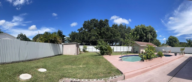 view of pool featuring a lawn and a shed