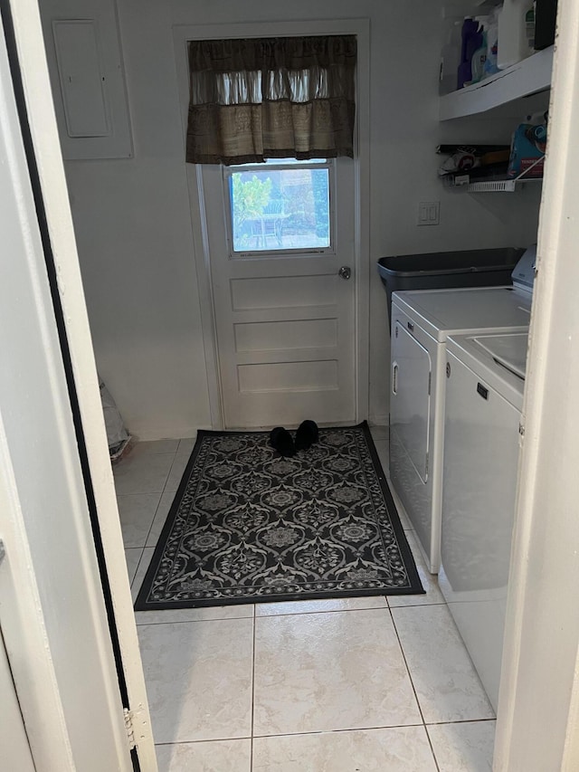 laundry room with independent washer and dryer and light tile floors