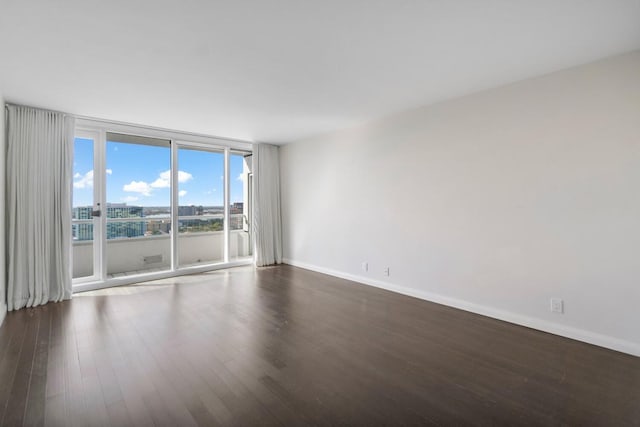 empty room featuring dark hardwood / wood-style flooring