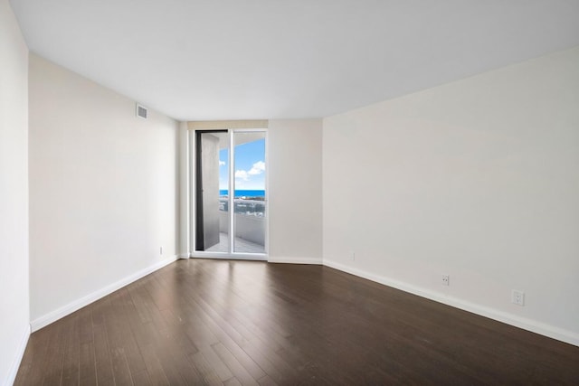 unfurnished room featuring dark hardwood / wood-style floors