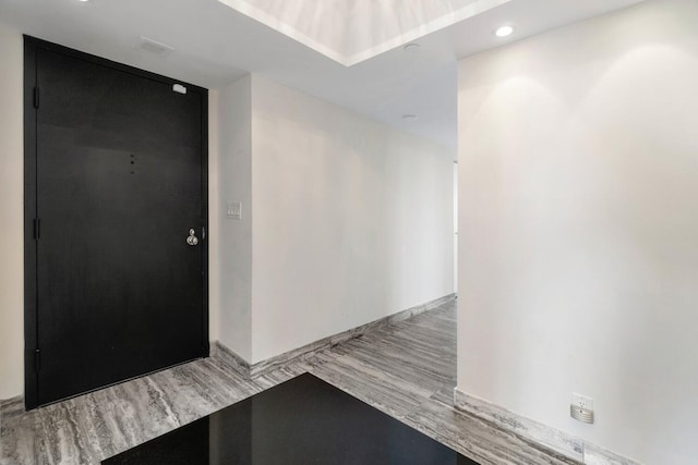 hallway with light hardwood / wood-style flooring