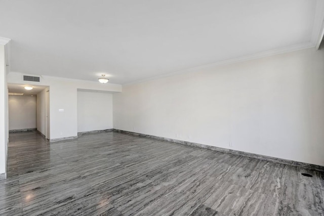 unfurnished room featuring ornamental molding and dark hardwood / wood-style floors