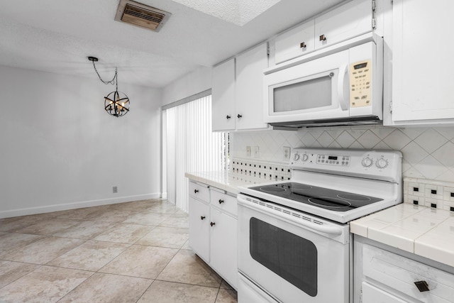 22230 Cameo Dr E, Boca Raton, FL 33433 - kitchen featuring white appliances, tile countertops, light tile patterned floors, visible vents, and white cabinetry