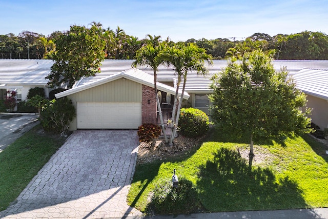 22230 Cameo Dr E, Boca Raton, FL 33433 - view of front facade with a garage, decorative driveway, brick siding, and a tiled roof