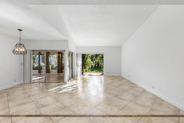 22230 Cameo Dr E, Boca Raton, FL 33433 - tiled spare room featuring baseboards, plenty of natural light, a textured ceiling, and an inviting chandelier