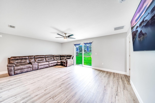 living room with ceiling fan and light hardwood / wood-style flooring