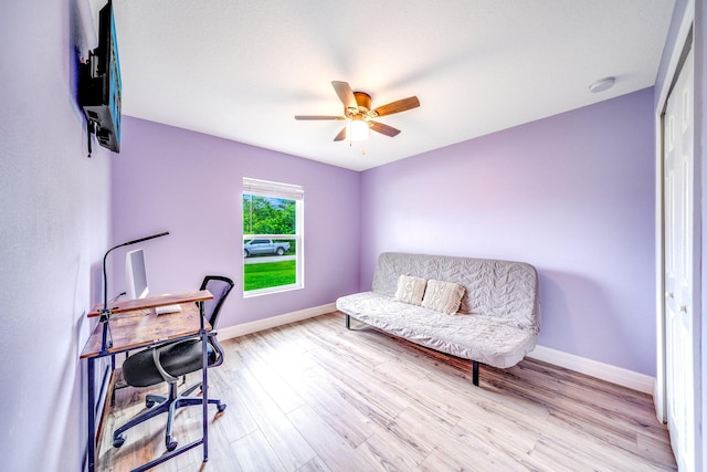 home office with ceiling fan and light wood-type flooring