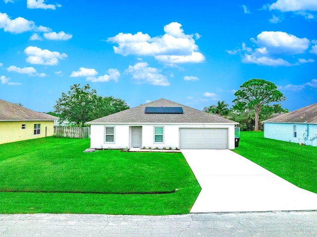 view of front of home featuring a front lawn, a garage, and solar panels