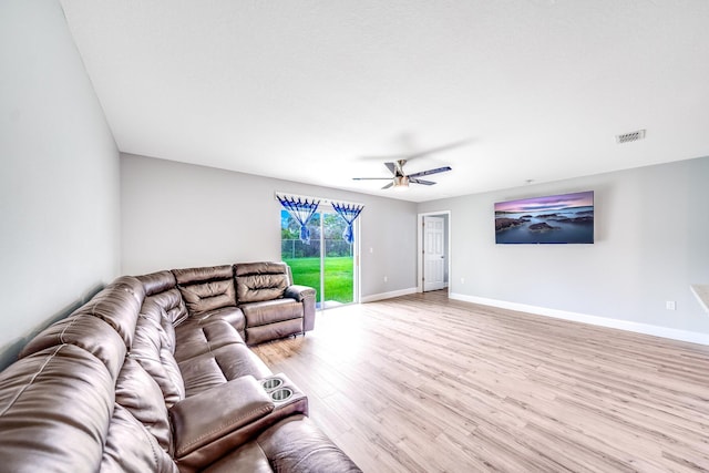 living room with ceiling fan and light hardwood / wood-style flooring