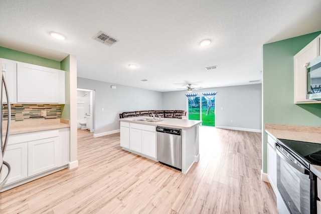 kitchen with dishwasher, ceiling fan, white cabinetry, light wood-type flooring, and sink