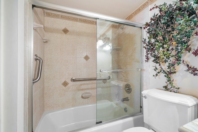 bathroom with bath / shower combo with glass door and toilet