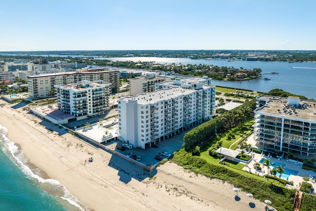 birds eye view of property with a beach view and a water view