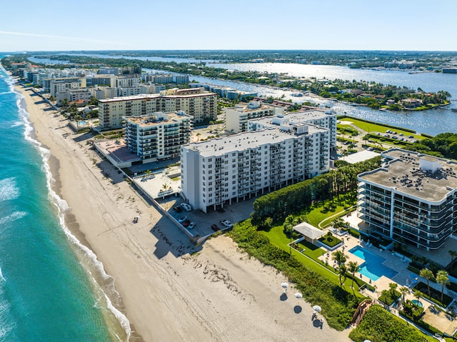 birds eye view of property with a water view and a view of the beach