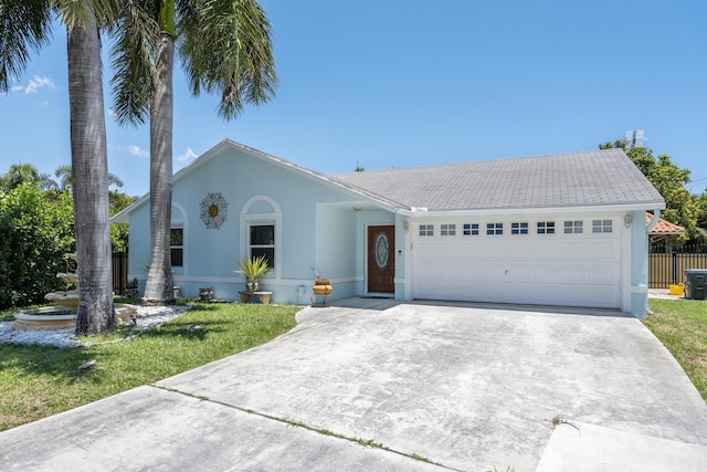 ranch-style house featuring a front yard and a garage