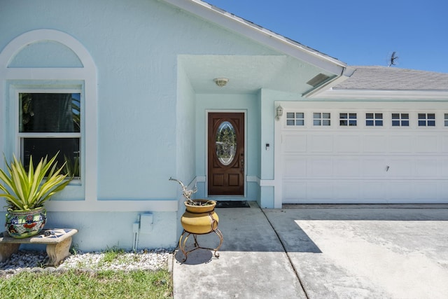 doorway to property with a garage