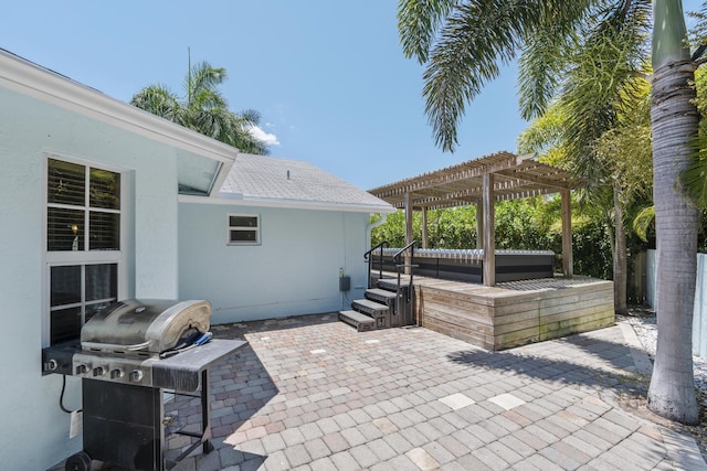 view of patio featuring area for grilling, a pergola, and a hot tub