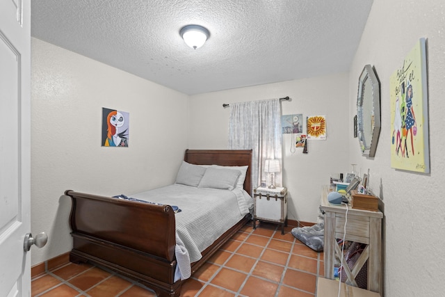 tiled bedroom with a textured ceiling