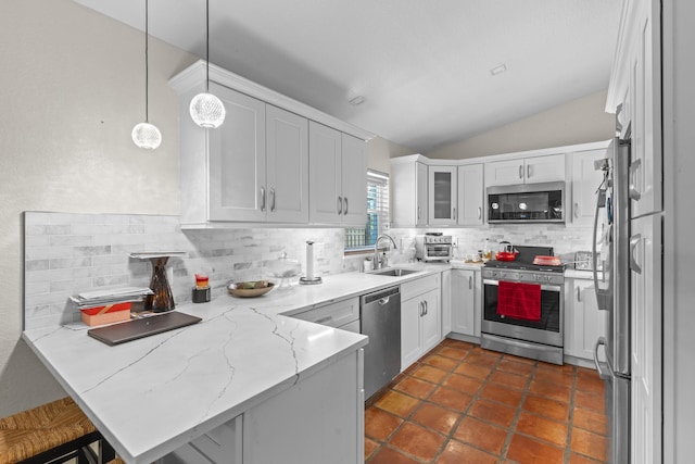 kitchen with kitchen peninsula, appliances with stainless steel finishes, decorative light fixtures, white cabinets, and lofted ceiling