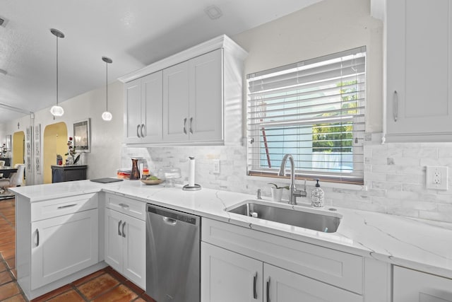 kitchen featuring pendant lighting, white cabinetry, sink, and stainless steel dishwasher