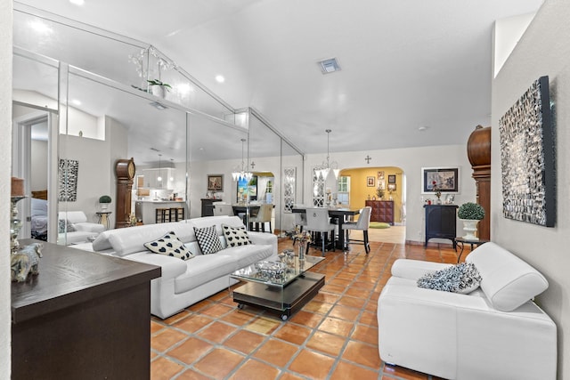 tiled living room with high vaulted ceiling