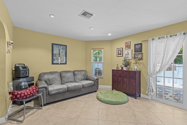 tiled living room with a textured ceiling