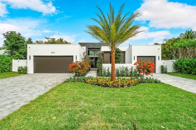 view of front of property with a front yard and a garage