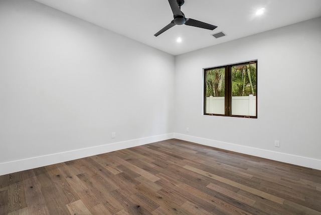 unfurnished room with dark hardwood / wood-style floors and ceiling fan