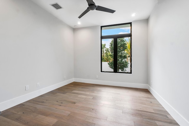 empty room with ceiling fan and light wood-type flooring