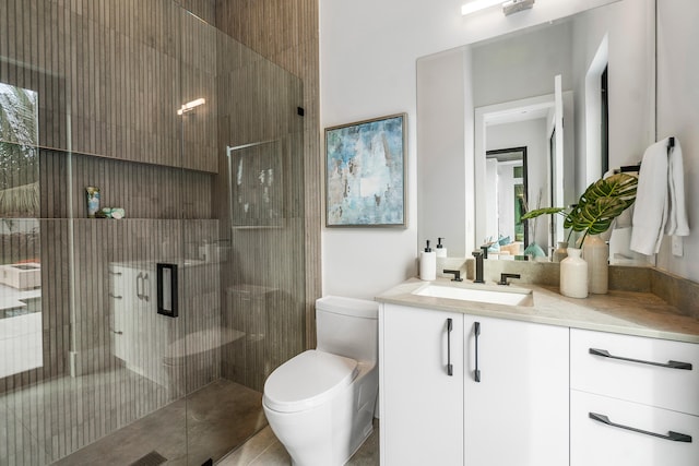 bathroom with toilet, large vanity, and a shower with shower door