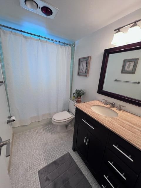 full bathroom with shower / tub combo, toilet, tile patterned flooring, and vanity