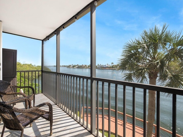 sunroom / solarium featuring a water view