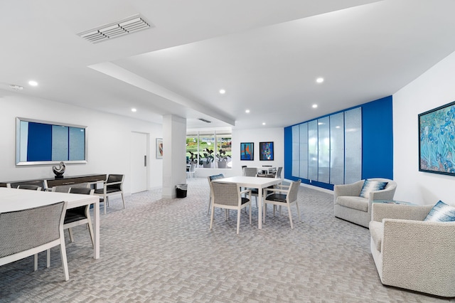 dining area featuring light colored carpet