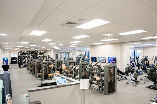 workout area with ceiling fan and a paneled ceiling