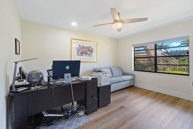 office space with ceiling fan and light hardwood / wood-style flooring