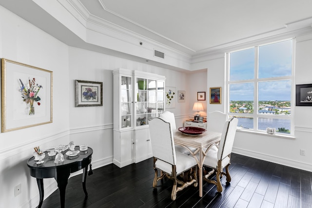 dining area with crown molding and dark hardwood / wood-style floors