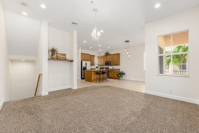 unfurnished living room with light carpet and a chandelier