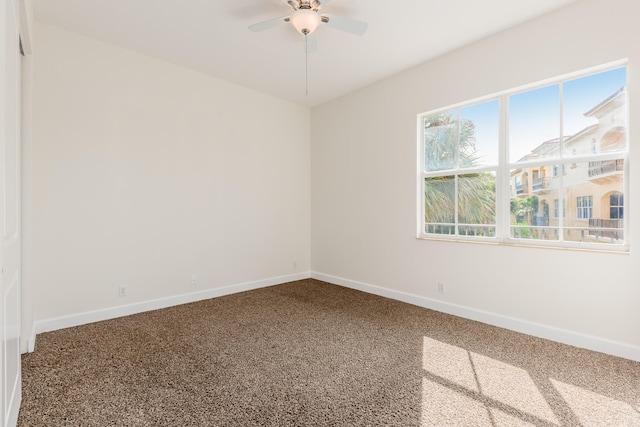 carpeted empty room with plenty of natural light and ceiling fan