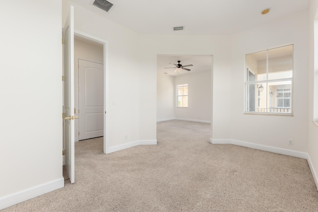 spare room with light carpet and ceiling fan