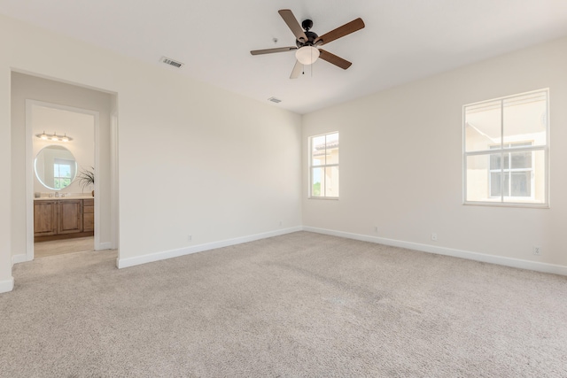 carpeted spare room with ceiling fan