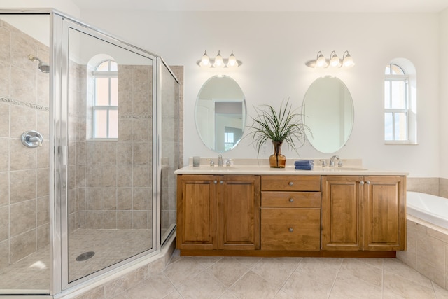 bathroom featuring double sink, shower with separate bathtub, tile flooring, and oversized vanity