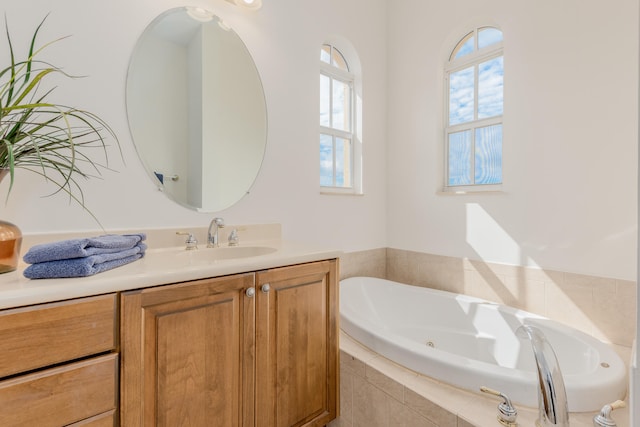 bathroom with vanity and a relaxing tiled bath