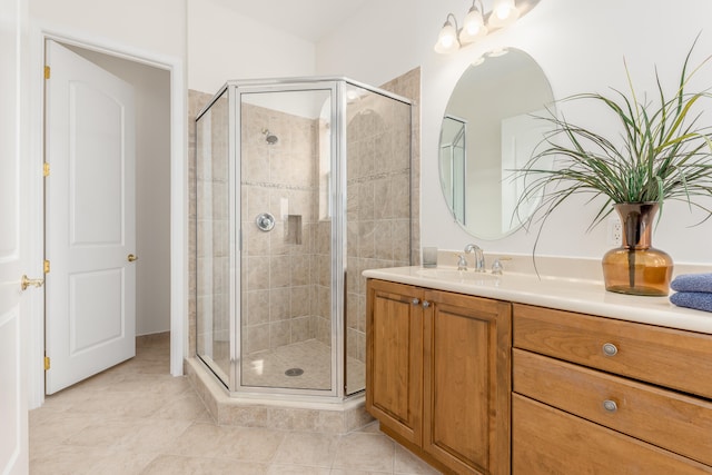 bathroom featuring tile flooring, walk in shower, and vanity