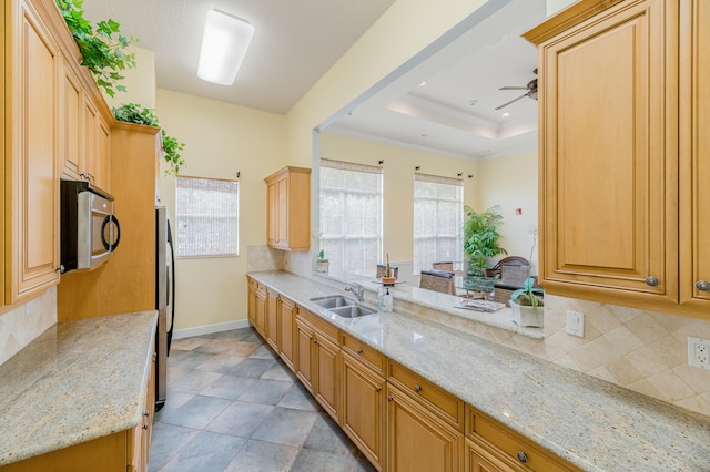 kitchen with appliances with stainless steel finishes, light stone countertops, ceiling fan, and light tile flooring