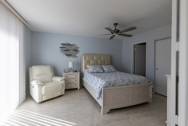 bedroom with light hardwood / wood-style floors and ceiling fan