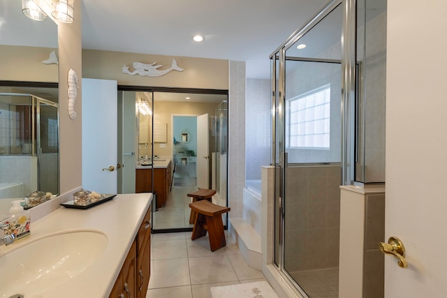 bathroom featuring tile floors, vanity, and a shower with door